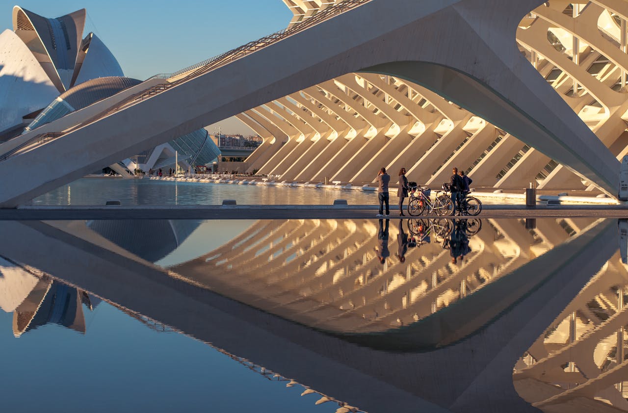 Striking view of Valencia's Ciudad de las Artes y las Ciencias reflected in tranquil water, showcasing modern architecture.
