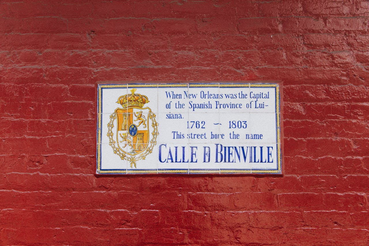 Street sign on a red brick wall, New Orleans, Spanish era history.