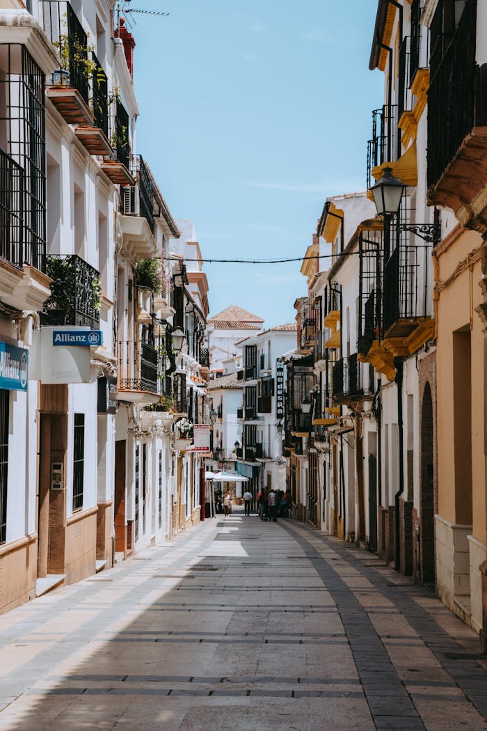 Explore the quaint pedestrian streets of Ronda, Spain, showcasing traditional Spanish architecture.